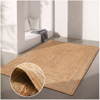 Beige jute rug on a gray floor with a close-up of the texture in the corner.