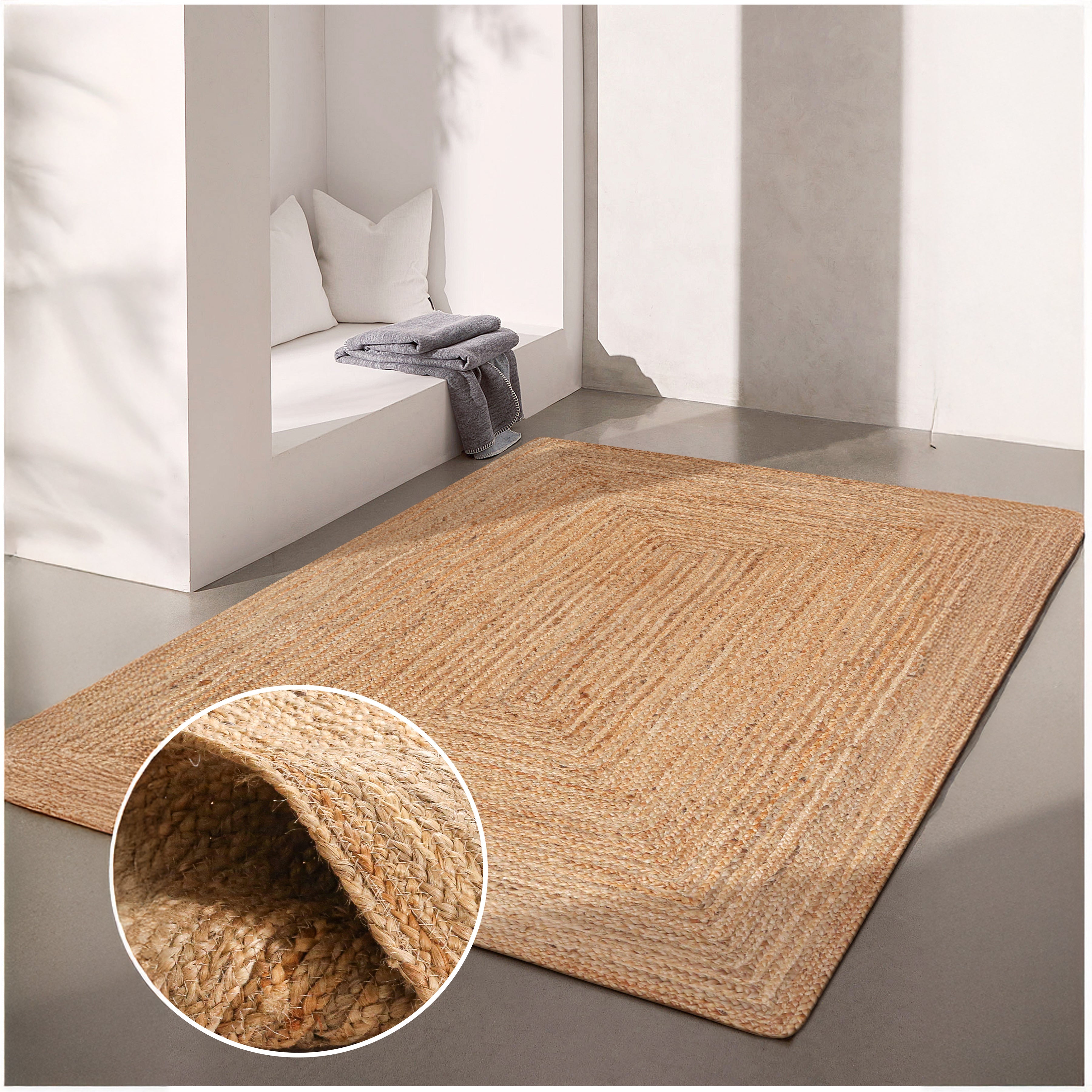 Beige jute rug on a gray floor with a close-up of the texture in the corner.
