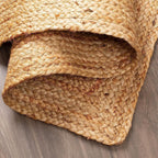 Close-up of a woven jute mat on a wooden surface